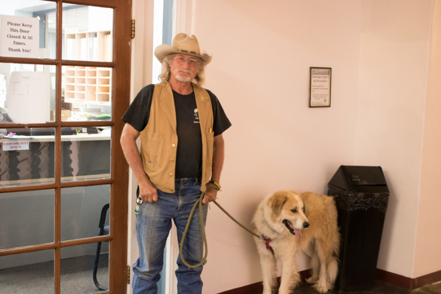 Gus Jolly and his therapy dog Otie attend the Chain Free Santa Fe hearing at the Board of County Commissioners in Santa Fe on Sept. 13. Photo by Chris Dorantes