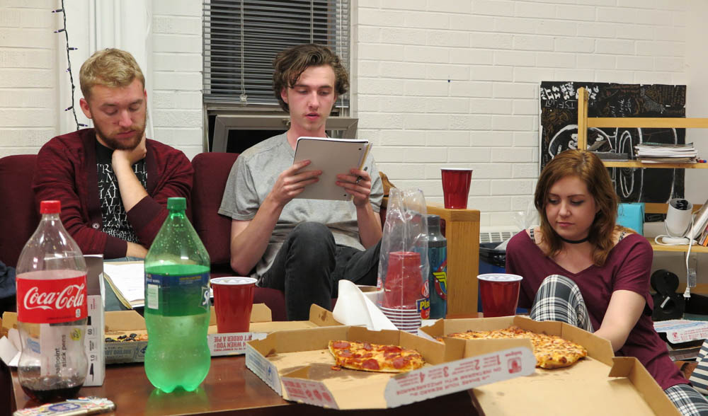 Duncan Calem and Kylie Yockey listen as Isaac Leigh reads his short story. Photo by Marisa Doherty. 