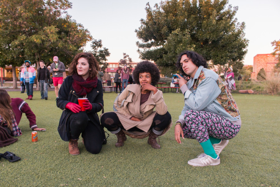 Students of Santa Fe University of Art and Design Melissa Schoonfield, Tawanda Suessbrich, and Kagan Marks eagerly await for the next band to take the stage at the City Different Festival. Photo by Yoana Medrano.