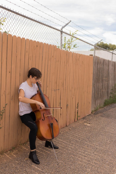 Lara White plays their cello in public to get some fresh air. Photo by Kaitlyn Sims.