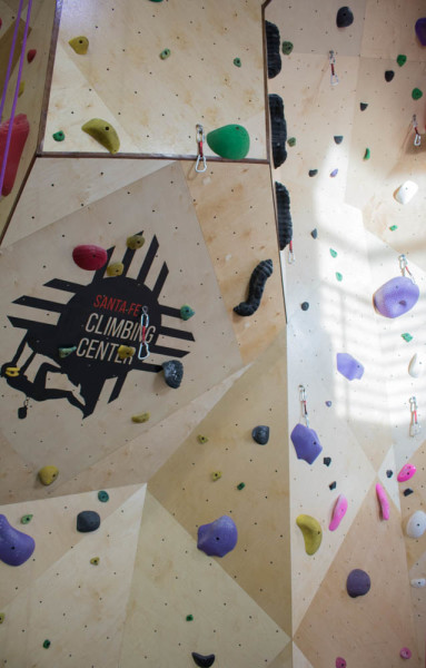 Logo of Climbing Center plastered in the middle of routes. Photo by Kaitlyn Sims.