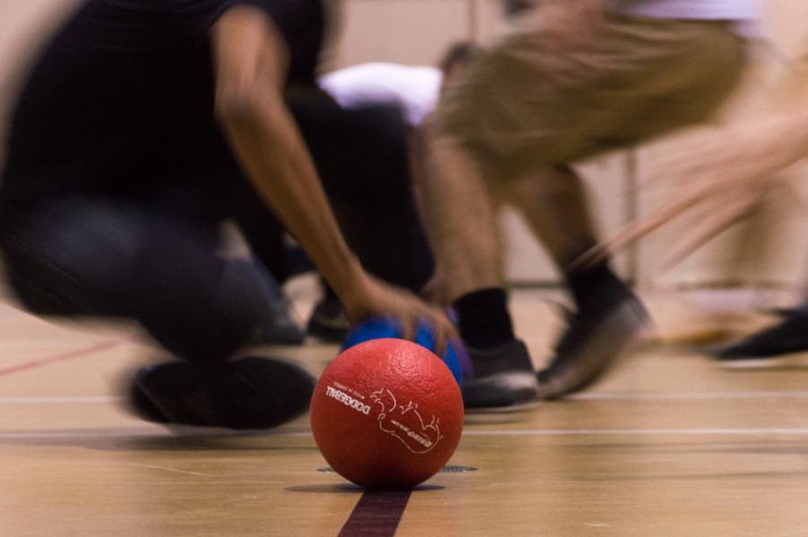 One of many dodgeball games of the night begins and students scramble to grab a ball in an effort to get members of the other side out. Photo by Jennifer Rapinchuk
