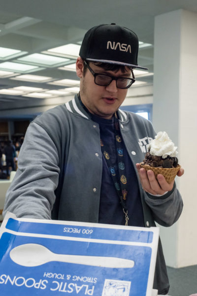 Sophomore Film major Jose Couvillion tops his sundae with whip cream. Photo by Sasha Hill