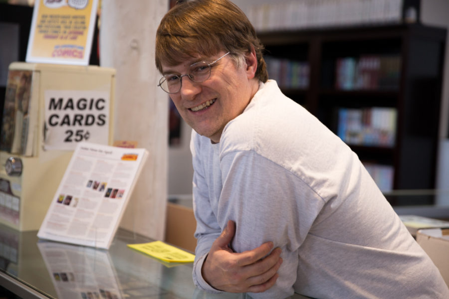 Kevin Drennan, owner of Big Adventure Comics, leans on the counter where he greets customers daily. Photo by Jason Stilgebouer