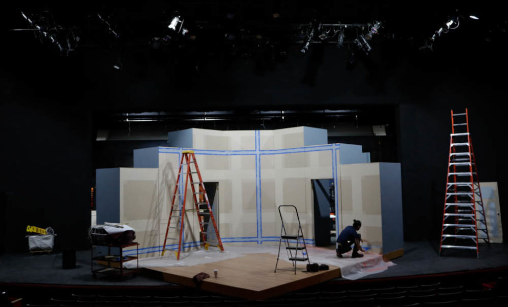 Shop manager Lucian D. Connole Completes painting the stage. Photo by Jesus Trujillo