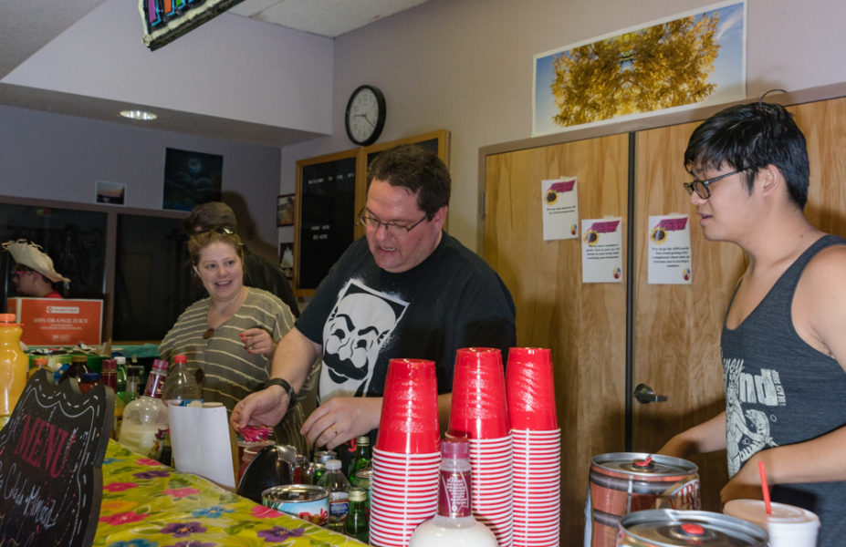 Shawn Khounphithack (right), Timothy Chambers and Heather Mazarow are bartenders taking orders for mixed drinks at the beach bash. Photo by Sasha Hill