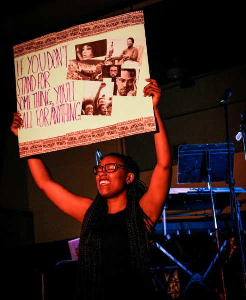 Cabria Scott holds up a sign for Black history month celebration. Photo by: Hawie Veniegas