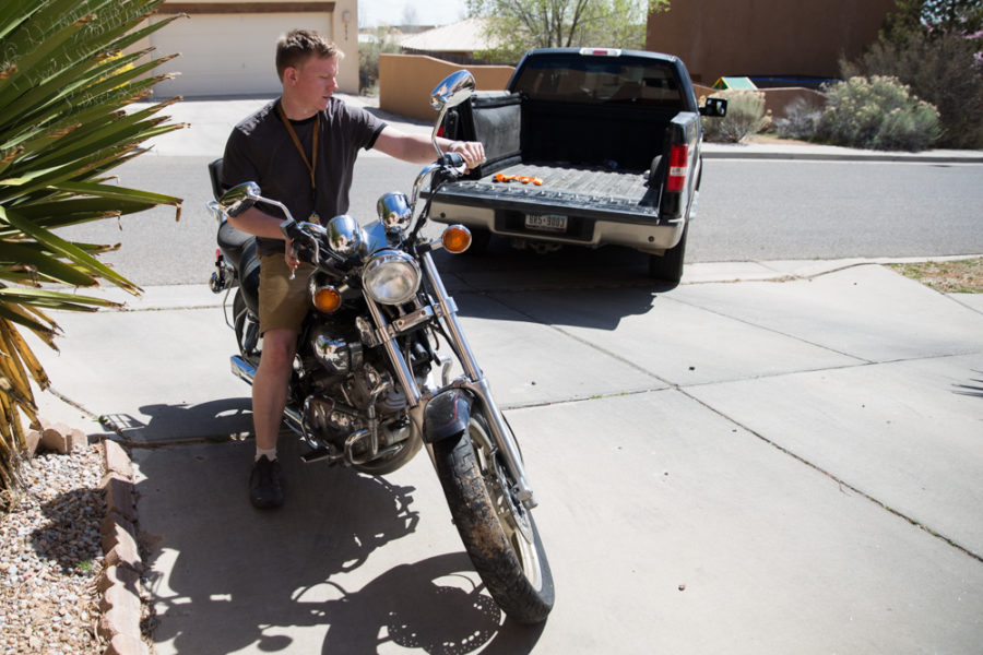  Ambrose Taylor moves his motorcycle as he prepares to take it back to campus. Photo by Jason Stilgebouer