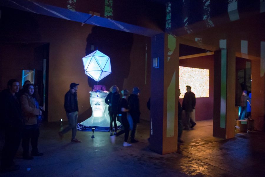 People gather at outdoor vision festival to look and interact with art pieces. Photo by Jason Stilgebouer