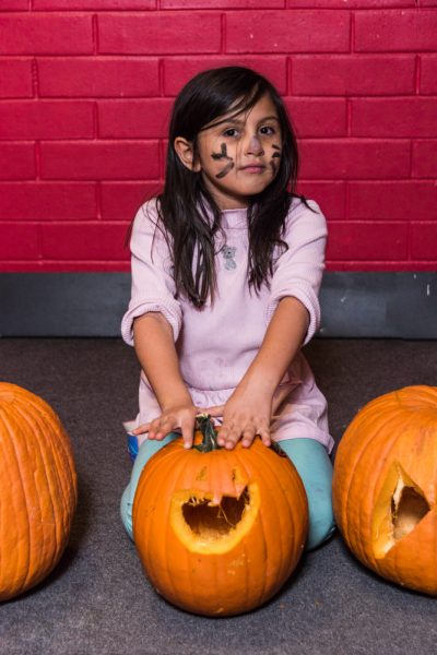 Alethia Hill sits with her carved pumpkin. Photo by Sasha Hill