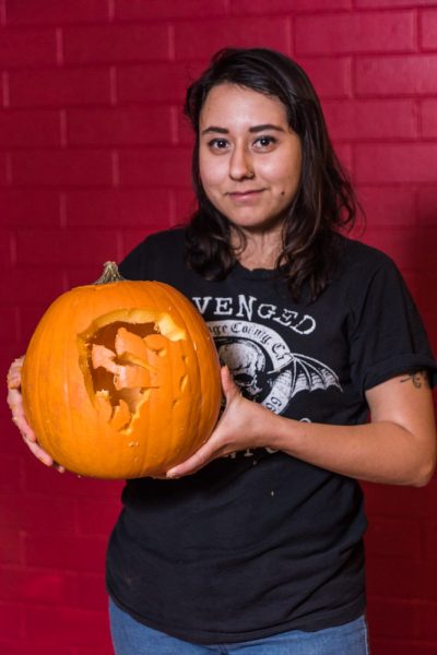poses with her pumpkin. Photo by Sasha Hill