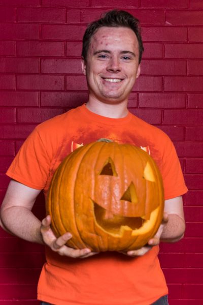Jack Getschman happily displays his carved pumpkin. Photo by Sasha Hill