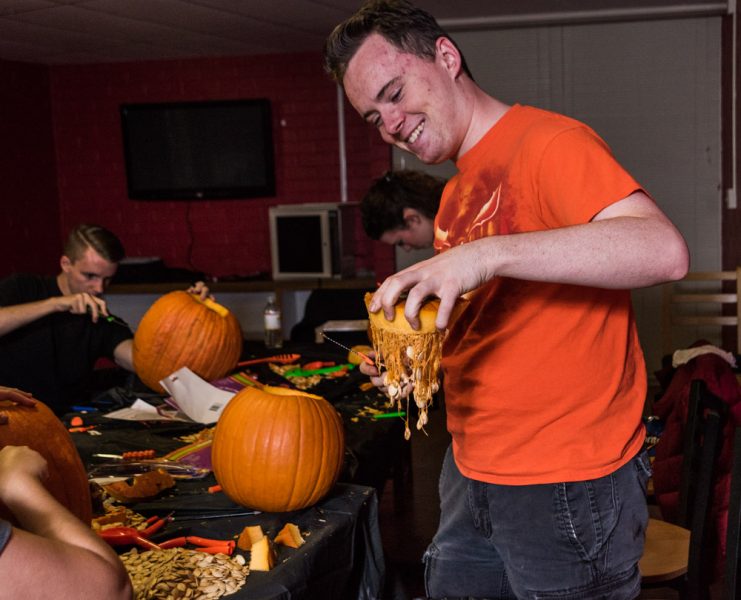 Jack Getschman hold up pumpkin guts. Photo by Sasha Hill